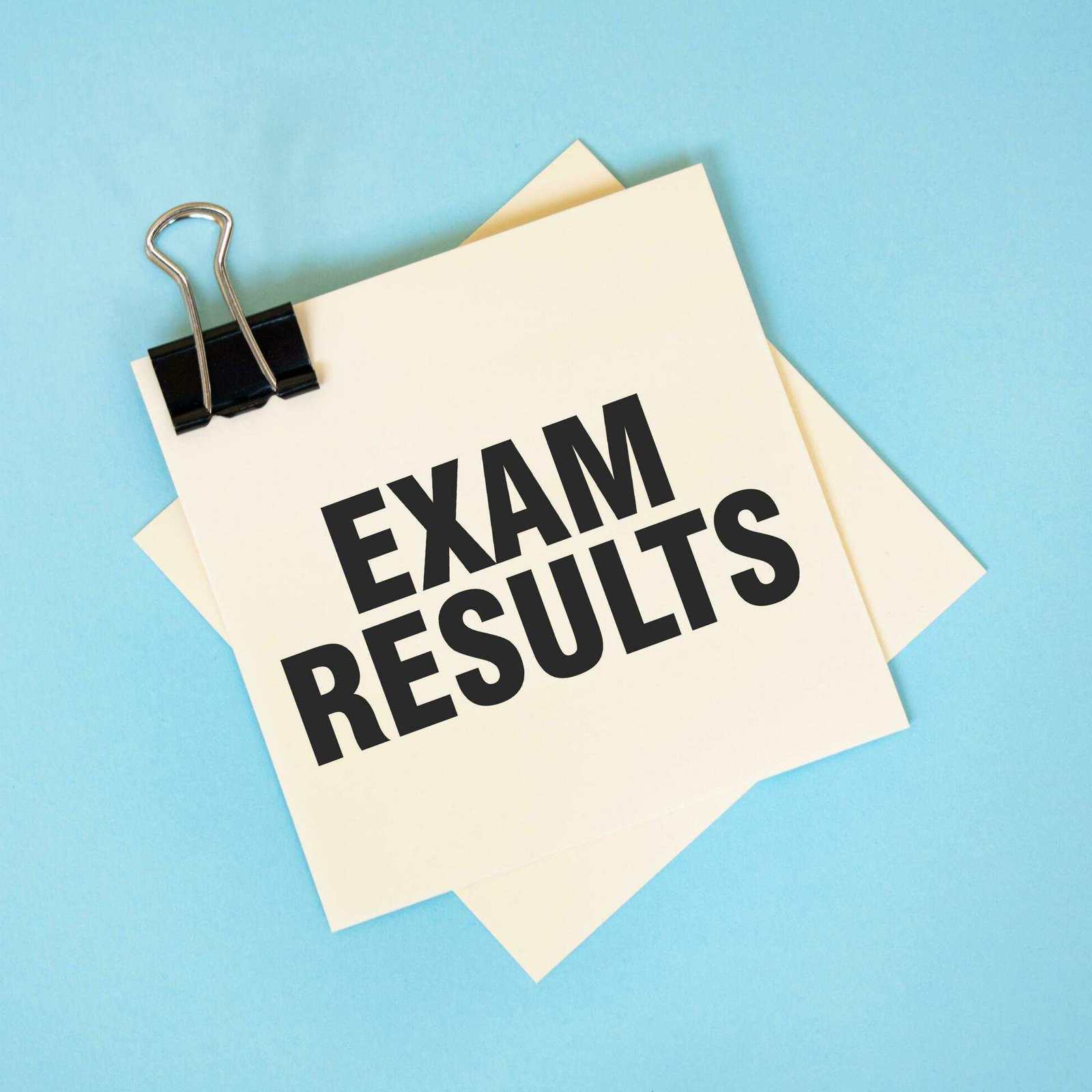 Text Exam Results On Sticky Notes With Copy Space And Paper Clip Isolated On Red Background Finance And Economics Concept Free Photo