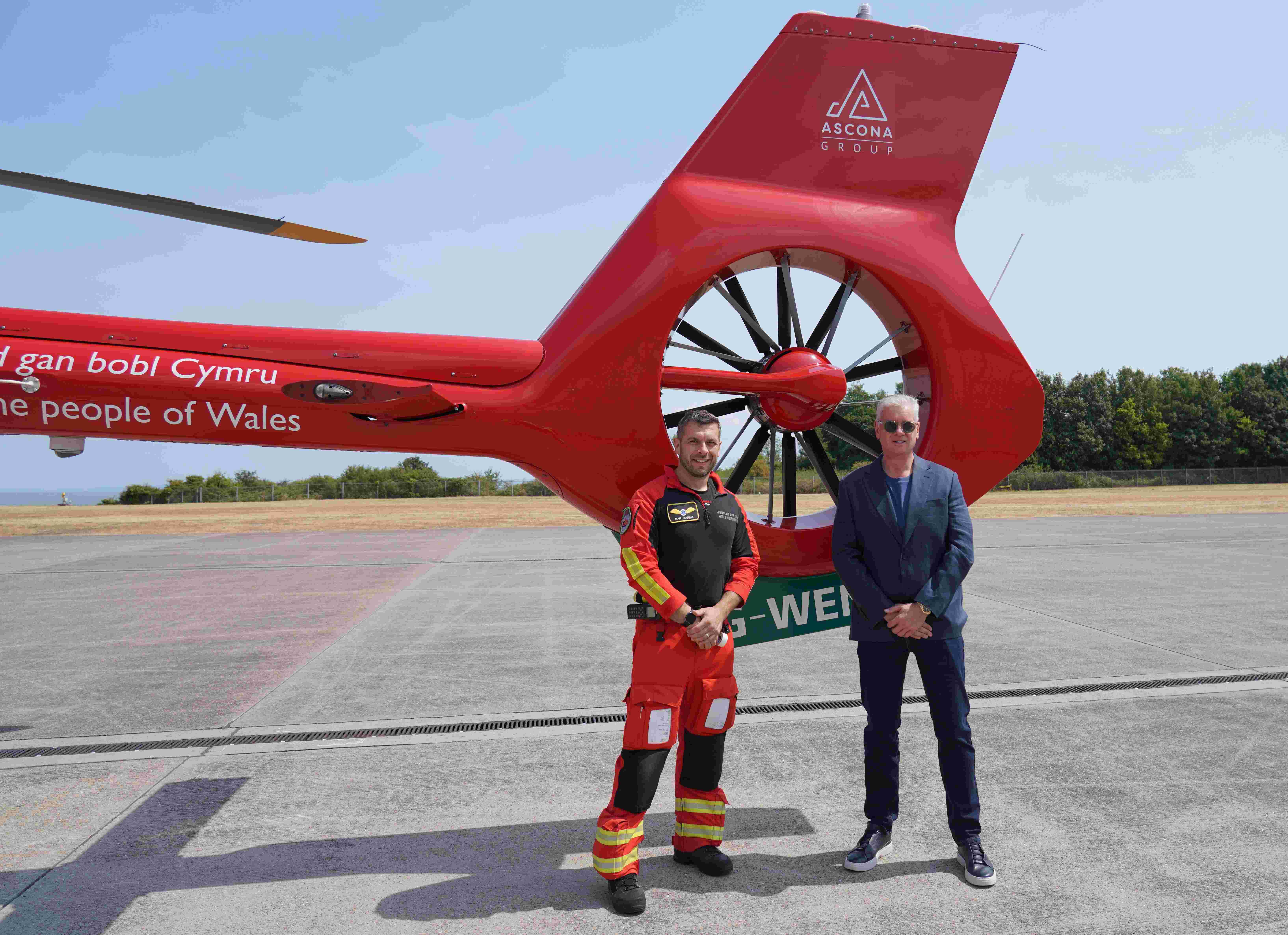 Wales Air Ambulance Crew With Ascona Group CEO Darren Briggs In Front Of The Branded Helicopter Tail