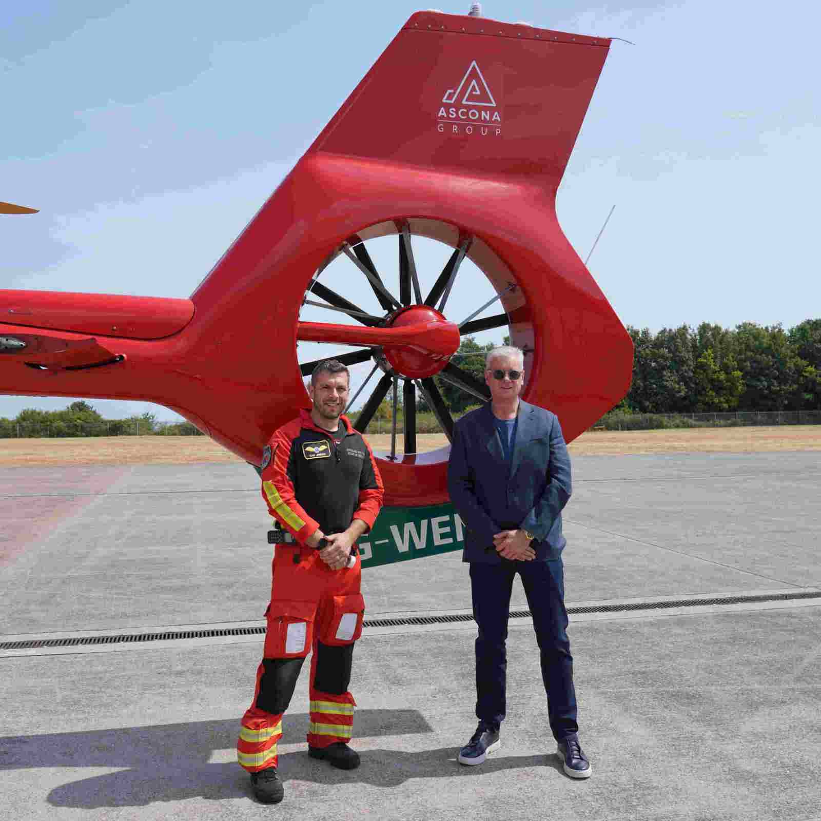 Wales Air Ambulance Crew With Ascona Group CEO Darren Briggs In Front Of The Branded Helicopter Tail