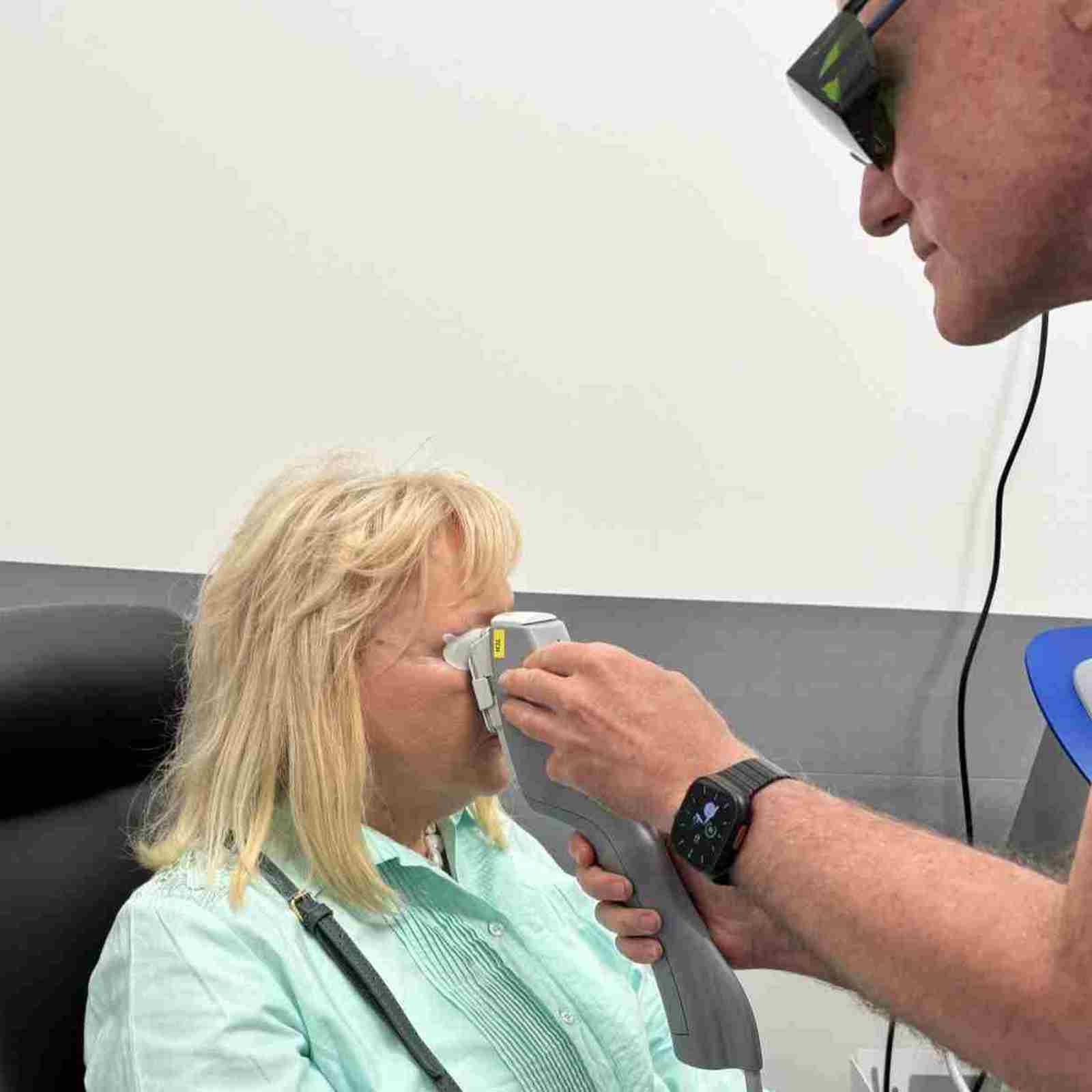 Specsavers Haverfordwest Director, Wayne Jones, Performs New Advanced Dry Eye Treatment On Pembrokeshire Local, Mrs Collette Dyer.